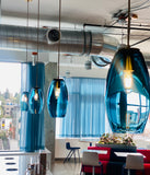 Modern interior with blue pendant lights and a cityscape view