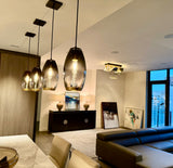 Modern living room with stylish furniture and decor, including 4 brilliant oval pendant lights