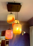 Modern pendant lights with colorful glass shades in a kitchen setting.