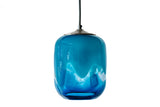 Ocean-themed glass pendant with an array of blues and white