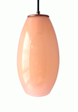 A soft pink hand-blown glass pendant light on a white background
