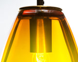 Close-up details of the ELETTRA gold topaz glass pendant, showing the red-to-yellow gradient and metal finish on the pendant's top