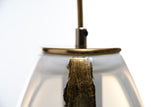 A close-up of a glass pendant with an added metal luxury stripe upgrade