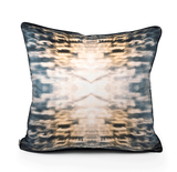 A square-shaped velvet throw pillow with a geometric pattern featuring blue and orange light effects, displayed on a white background