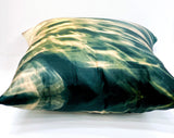 A square-shaped silk throw pillows with a geometric pattern featuring blue and orange light effects, displayed on a white background on its back