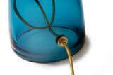 Close-up of the blue glass base and gold cord of the Lumi Collection lamp, the Perfect Statement Table Lamp for the living room, Office, or Bedside. 