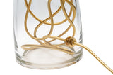 The gold-colored cord from the inside of a glass lamp's base to the outside to be plugged in