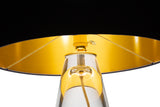 Interior of the SERAFINA gold lamp top as a light bulb reflects the inside gold coloring 