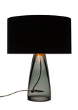 A modern and classy grey glass and black top lamp with visable copper cording passing through the lamp