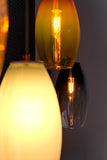 4 hand-blown glass pendants displayed in a line and brightly shining!