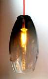 Hand-blown, mold-formed glass pendant with a grey fade color, illuminating beautifully.