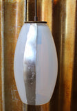 A shiny and eyecatching opaline colored glass pendant with silver contour luxury upgrade detailing.