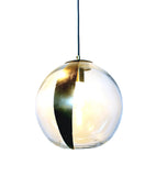Close up of the HELIO clear sphere glass pendant light with a gold leaf detailing