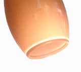 A close-up of the bottom of an ELETTRA rose quartz hand-blown glass pendant light.
