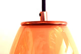 The top of the ELETTRA pendant light in the rose quartz color with copper metal finish and a black cord