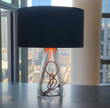 A glass bottom, showing copper cording and black top lamp in a Seattle condo.